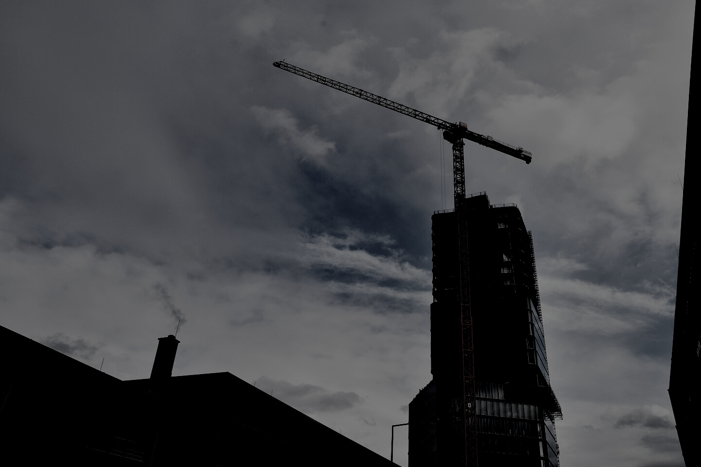 Yellow Tower Crane Beside the Concrete Building